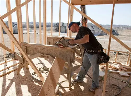 Construction worker Nate McCabe saws a board at a single family home construction site in Omaha, Neb., Monday, March 16, 2009. The Commerce Department reported Tuesday that housing construction surged 22.2 percent in February to a seasonally adjusted annual rate of 583,000 units. Even with the big gain, which took economists by surprise, construction activity is 47.3 percent below the level of a year ago as the housing sector remains mired in its worst slump in decades. (AP Photo/Nati Harnik)